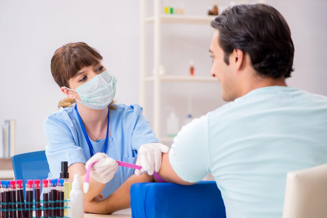 Nurse taking blood from patient