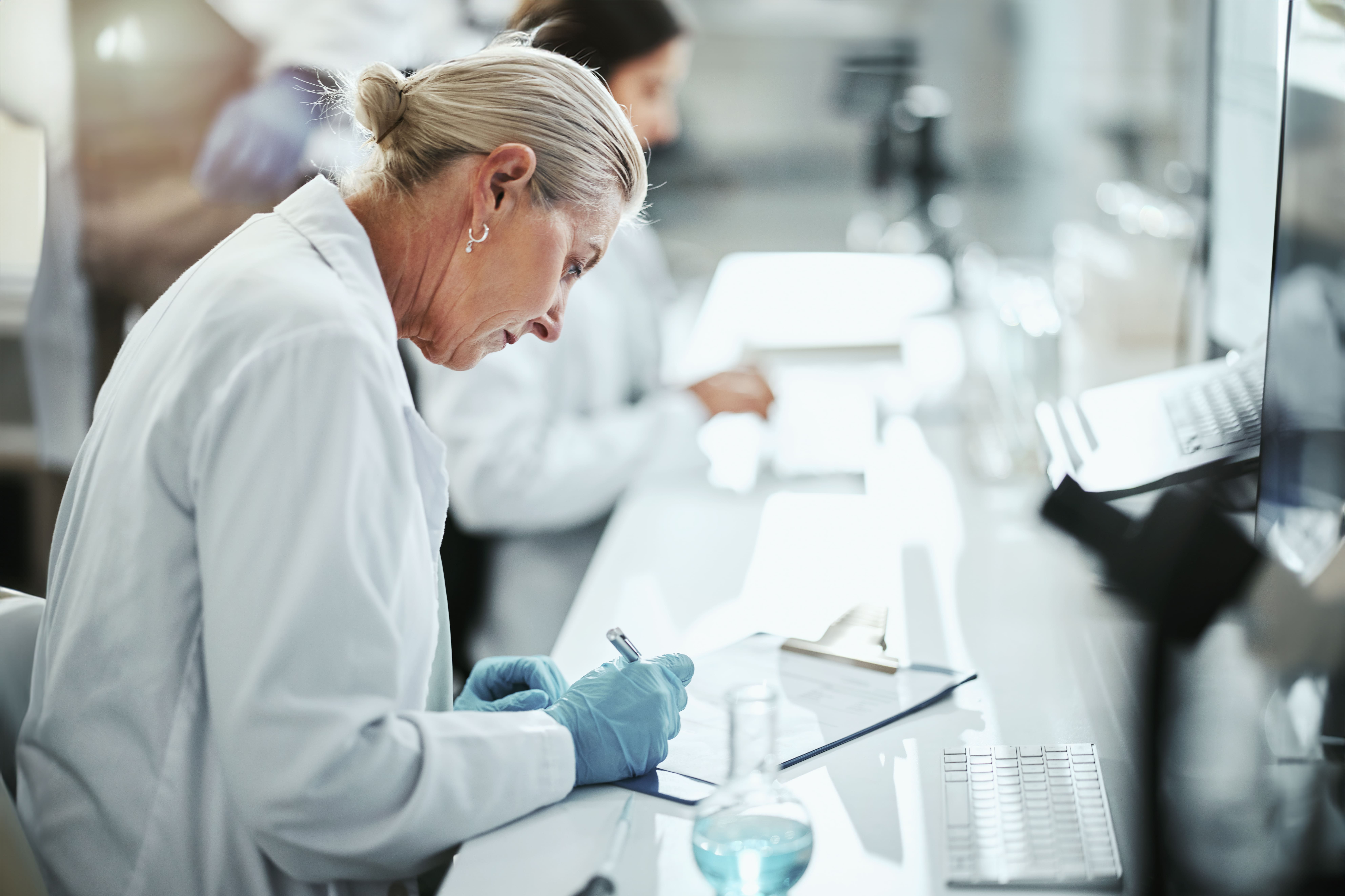 Woman researcher writing note on pad