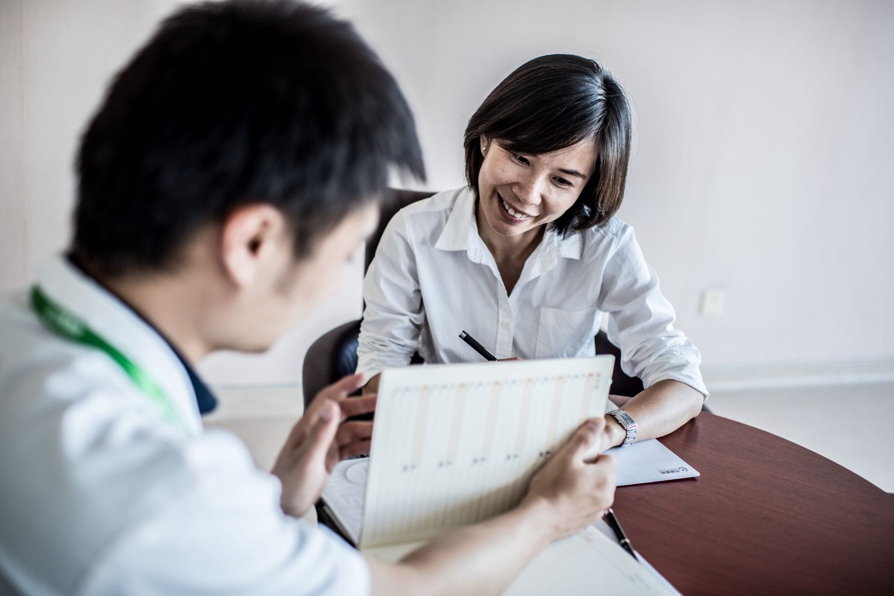 Two World Courier colleagues discussing chart