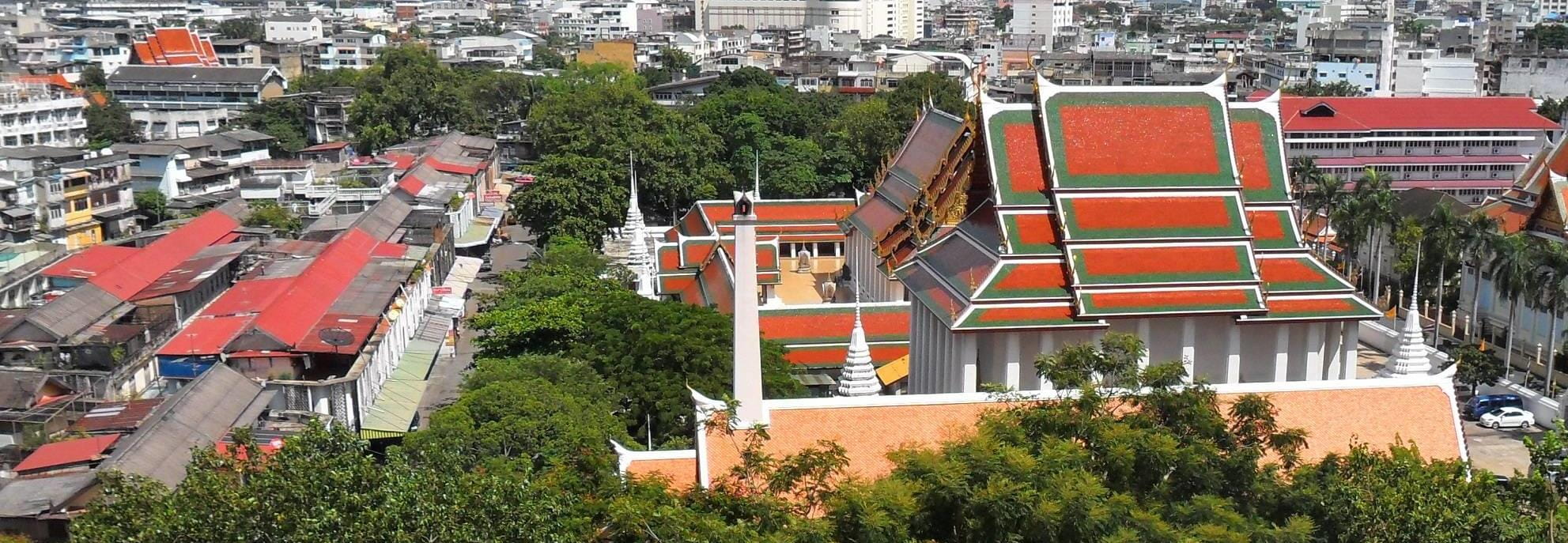 An aerial view of a temple and the surrounding city in Bangkok, Thailand.