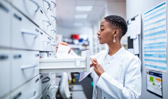 Medical professional sorting through files and prescriptions