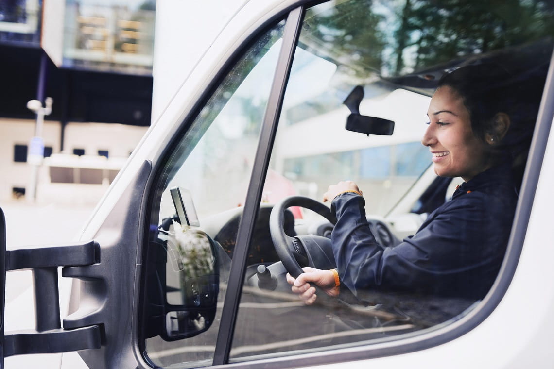 Female driver in a World Courier delivery van
